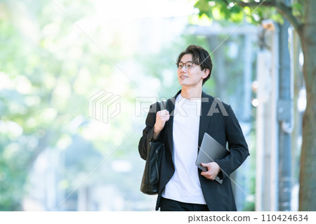 man walking with computer 110424634
