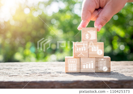Fiscal year concept, Hand holding wooden block with fiscal year icon on virtual screen. 110425373