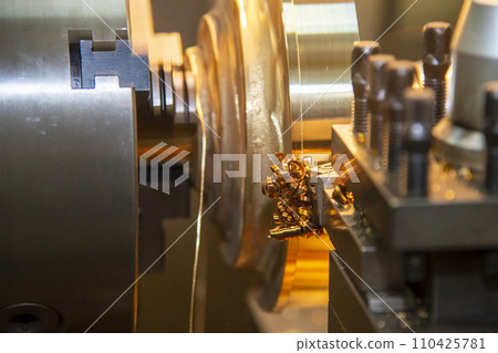 Closeup scene the lathe machine finish cut the brass parts by lathe tools. Closeup scene the lathe machine finish cut the brass parts by lathe tools. 110425781