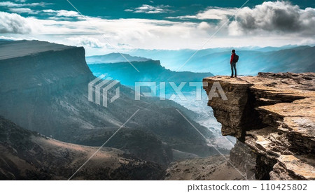 person looking at magnificent mountains person looking at magnificent mountains 110425802