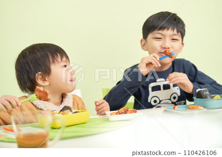 Two boys eating delicious lunch 110426106