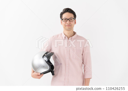 man holding a motorcycle helmet 110426255