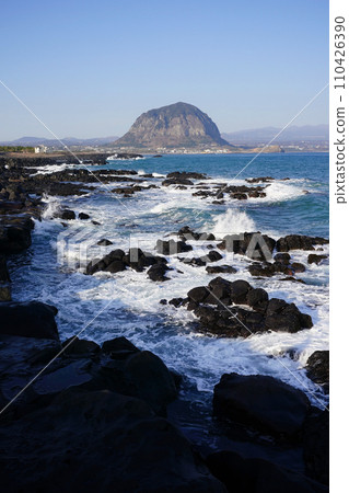 Sanbangsan Mountain seen over the waves breaking on the rock 110426390