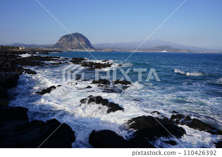 Sanbangsan Mountain seen over the waves breaking on the rock 110426392