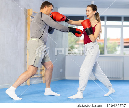 Woman and man boxing in gym Woman and man boxing in gym 110426737