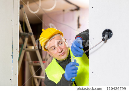 Electrician working with wires in apartment 110426799