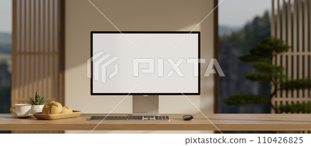 A modern home workspace with a white-screen PC computer mockup on a hardwood desk. 110426825