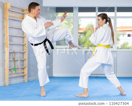 Woman and man in kimono exercising 110427304