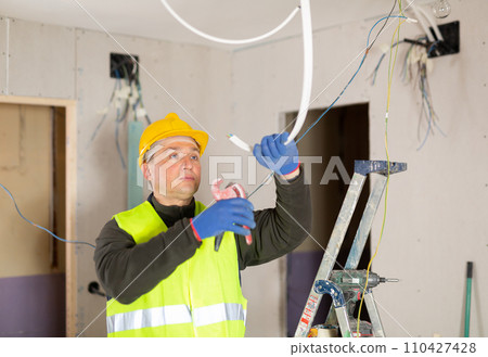 Electrician working with wires in apartment 110427428