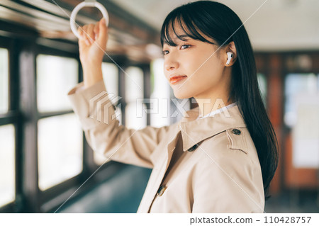 Woman listening to music by train 110428757