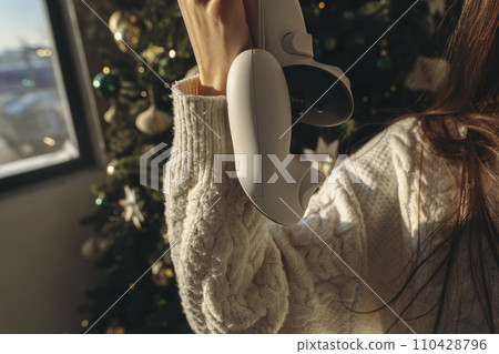 An energetic young girl was gifted a virtual reality headset for Christmas. An energetic young girl was gifted a virtual reality headset for Christmas. 110428796