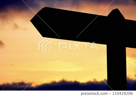 Silhouetted directions sign 110429206