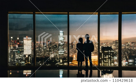 Couple looking at the night view of the city from the window of a high-rise building AI image AI generated image 110429618