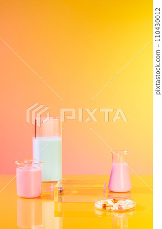 A handful of pills contained inside a petri dish, displayed with an empty podium and some glassware of pastel color liquid. Mock-up for exhibitions or presentation of cosmetic products or packaging A handful of pills contained inside a petri dish, displayed with an empty podium and some glassware of pastel color liquid. Mock-up for exhibitions or presentation of cosmetic products or packaging 110430012