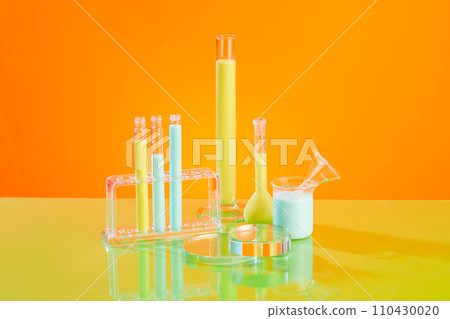 A stack of glass podiums in round shaped displayed with some laboratory glassware of blue and yellow liquid. Pedestal or platform for beauty products presentation 110430020
