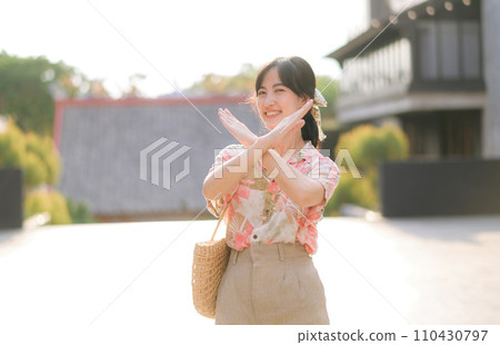 Portrait beautiful young asian woman on summer holiday vacation trip in Thailand. Young hipster female tourist sightseeing summer urban Bangkok destination. Asia summer tourism concept. 110430797