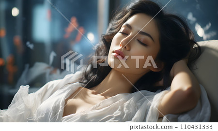 A beautiful young woman wearing a white robe lies on the coach with her eyes closed. It can mean many things ex She is resting, Waiting to receive beauty services or waiting to receive health service. A beautiful young woman wearing a white robe lies on the coach with her eyes closed. It can mean many things ex She is resting, Waiting to receive beauty services or waiting to receive health service. 110431333