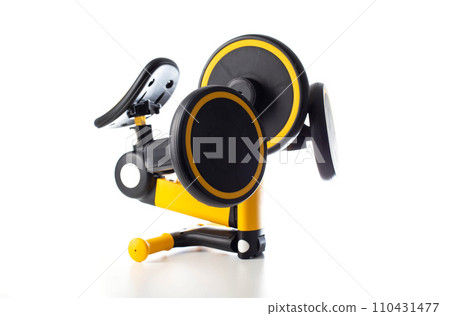Children's transforming balance bike on a white background. Children's yellow bicycle, close-up. Isolate 110431477