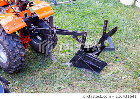 Plow and hiller complete with a walk-behind tractor for agricultural work. Plow and hiller complete with a walk-behind tractor for agricultural work. 110431641