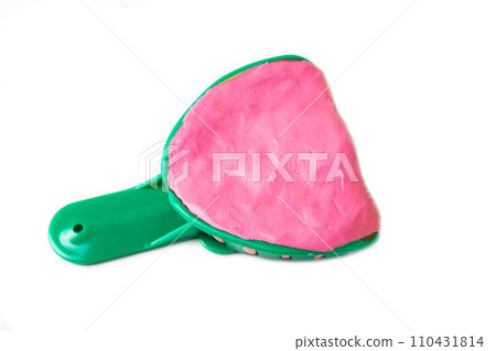 Green dental tray with alginate plastic mass for taking an impression of the dental jaw on a white background, isolate. Orthodontics in dentistry, making an impression of the patient s dental jaw. Green dental tray with alginate plastic mass for taking an impression of the dental jaw on a white background, isolate. Orthodontics in dentistry, making an impression of the patient s dental jaw. 110431814