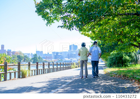 Active senior couple walking for health, diet, exercise, walk, backlight, morning color 110433272