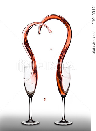 Shape of heart splashes out from two wine glasses. White isolated background 110433394