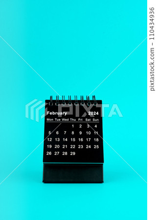Black Calendar for February 2024. Desktop calendar on a green background. Black Calendar for February 2024. Desktop calendar on a green background. 110434936