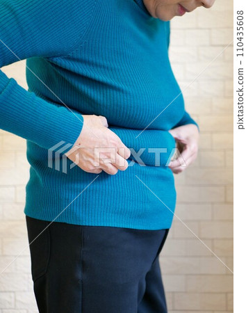 Sideways view of an elderly woman suffering from obesity 110435608
