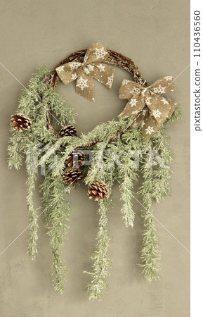 New Year's decorative wreath on a beige wall New Year's decorative wreath on a beige wall 110436560