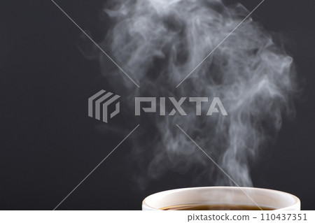 AI-generated image Steam rising from a cup on a black background AI-generated image Steam rising from a cup on a black background 110437351