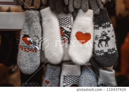 Colorful mittens on stalls of Christmas market in winter. Street sale market 110437420