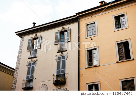 Como, Italy, historic city architecture. A building with the characteristic facade and windows. Summer day Como, Italy, historic city architecture. A building with the characteristic facade and windows. Summer day 110437445