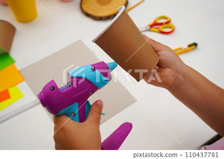Step by step diy process. Point 3 Glue the halves of the glass onto the cardboard. Kids craft giraffe from a paper coffee cup, zero waste concept. 110437781
