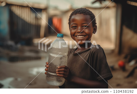 African boy with water bottle in hand. Black boy enjoying the water. African boy with water bottle in hand. Black boy enjoying the water. 110438192