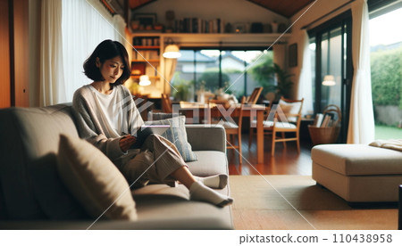Woman sitting on a sofa (AI generated) 110438958
