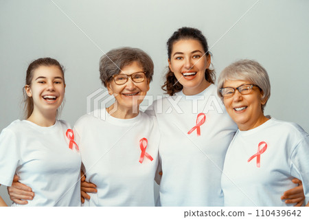 Smiling women with pink satin ribbon 110439642