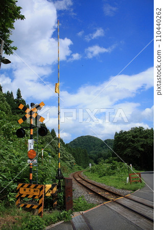 夏日的天空、鐵路道口和陸羽東線（日本宮城縣大崎市鳴子溫泉） 110440262