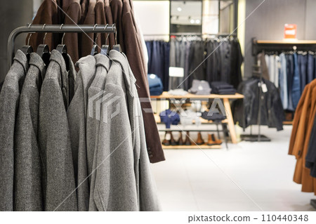 Men's casual clothing store, gray jackets on the hangers 110440348