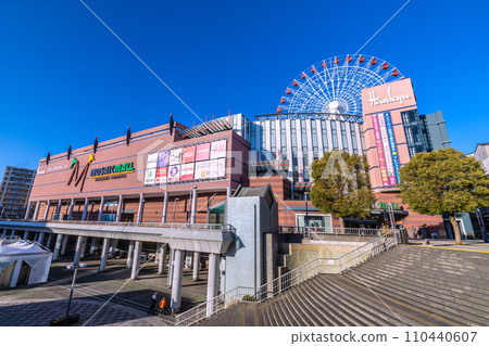 Yokohama cityscape in Japan January. In front of Center Kita Station, looking at the Ferris wheel and Tsuzuki Hankyu train against the blue sky = January 9, 2020 110440607