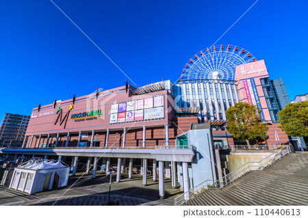 Yokohama cityscape in Japan January. In front of Center Kita Station, looking at the Ferris wheel and Tsuzuki Hankyu train against the blue sky = January 9, 2020 110440613