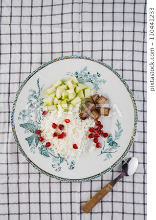 Breakfast of cottage cheese, green apple and pomegranate seeds Breakfast of cottage cheese, green apple and pomegranate seeds 110441233