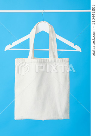 A white bag on a hanger on a blue background 110441803