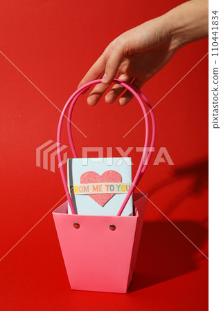 Surprise for Valentine's Day on a red background. 110441834