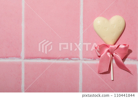 Heart on a stick, accessory for Valentine's Day on a pink background. 110441844
