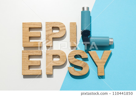 Epilepsy day written in wooden letters with inhalers 110441850
