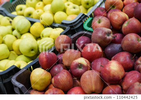 Red and green apples in the boxes in grocery store. ripe apples Red and green apples in the boxes in grocery store. ripe apples 110442425