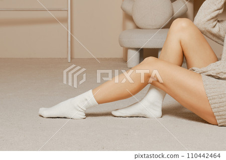 Perfect legs of woman in white cotton socks Perfect legs of woman in white cotton socks 110442464