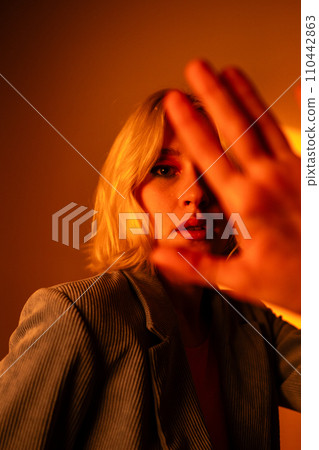 Vertical view of fashionable portrait of blonde lady in sunglasses posing.  110442863