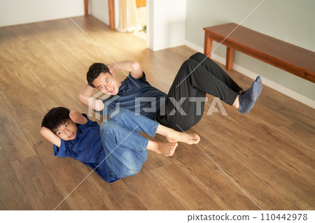 Elementary school students and adult men stretching side by side 110442978