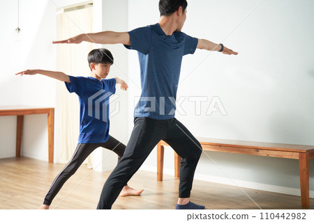 Elementary school boy receiving instruction in kids stretching 110442982